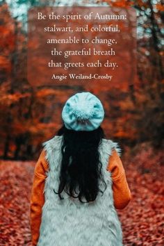 a woman standing in the woods with an autumn quote