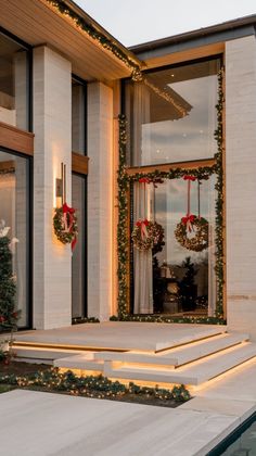 a house decorated for christmas with wreaths and lights