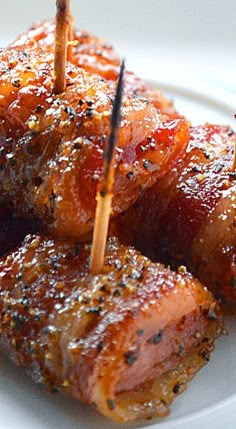 some food is on a white plate with toothpicks