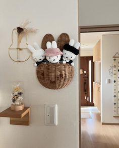 the wall is decorated with bunny ears and stuffed animals in a basket on it's side