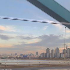 the city skyline is seen from an overpass in this view looking out at the water