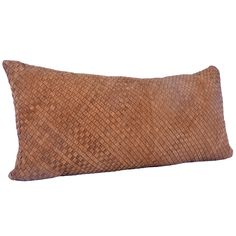 a brown woven pillow on a white background