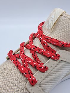 Red hybrid shoelaces with black and white flecks - a cool tri-color design that will make your shoes stand out.  We call these shoelaces 'hybrid' because they are halfway between round and flat.  This oval shaped lace is approximately 5/16" wide. Many colors are available but if you don't see the combination you want feel free to reach out to us. Your shoes will look great with a new set of quality hand crafted shoelaces made one at a time on our antique braiding machines in St. Louis, MO, USA A Red Casual Sneakers With Laces, Casual Red Sneakers With Laces, Red Sneakers With Elastic Laces For Streetwear, Red Breathable Lace-up Sneakers, Red High-top Sneakers With Elastic Laces, Red Outdoor Sneakers With Laces, Red Sporty Sneakers With Elastic Laces, Sporty Red Sneakers With Elastic Laces, Red Sneakers With White Laces For Sports