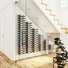 there is a wine rack in the middle of the room with many bottles on it