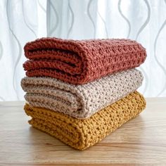 three crocheted blankets stacked on top of each other