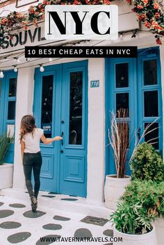 a woman walking into a restaurant with blue doors and flowers on the front door, in new york city