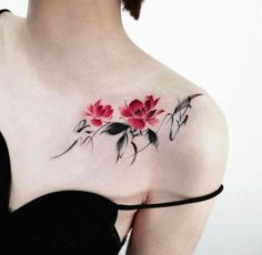 a woman's chest with flowers and leaves on the back of her body,