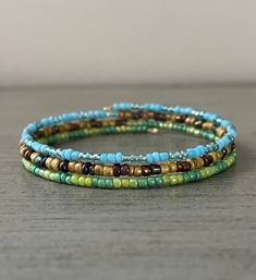 multicolored beaded bracelets on wooden table