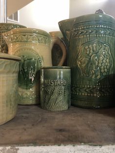 green pottery is sitting on a shelf in a room