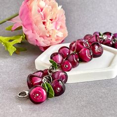 This wonderful handmade pomegranate bracelet is made of handmade lampwork glass beads. The seeds are so natural that some may be tempted to taste it. Each seed is made separately by me using lampwork technique. Вelicate leaves are made by me from polymer clay and have the texture and color of real leaves.   You will always be the center of attention with this original bracelet. Wear this bracelet to make a statement, whether it's a casual day out or a special event - it's a versatile piece that complements any occasion. The bracelet's rich red color represents energy and passion, adding a bold touch to your outfit. The glass Pomegranate Seeds bracelet is a charming piece of jewelry that will make a perfect gift for yourself or anyone who values handcrafted, quality items. The bracelet is d Handmade Burgundy Bracelets As Gift, Handmade Burgundy Bracelet As A Gift, Pomegranate Bracelet, Red Glass Jewelry, Raspberry Jewelry, Coffee Bracelet, Fruit Bracelet, Red Leather Bracelet, Bracelet Original