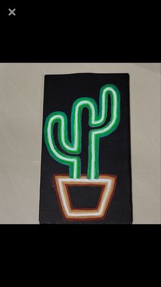 a green and orange cactus in a pot on a black background with white border around it