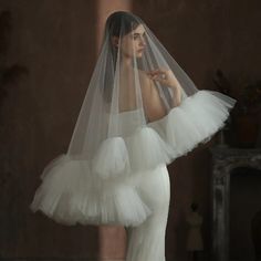 a woman in a wedding dress with a veil on her head