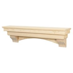 a wooden shelf sitting on top of a white wall