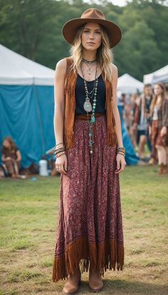 Get ready for festival season with this boho-inspired outfit! Featuring a flowy maxi dress, a stylish fringe vest, and chic ankle boots, this look is perfect for dancing the day away. Complete the ensemble with layered jewelry to add a touch of bohemian charm. Whether you're heading to a music festival or a summer fair, this outfit ensures you stay comfortable and fashionable. Embrace your free spirit and stand out in the crowd!  : #BohoStyle #FestivalFashion #MaxiDress #FringeVest #AnkleBoots #LayeredJewelry #BohoChic #OOTD #FestivalOutfit #BohemianFashion Bohemian Vest Outfit, 90s Hippy Fashion, Layering Maxi Dress Outfit, Boho Layered Outfits, Folk Festival Outfits, Curvy Boho Fashion, Boho Vest Outfit, Bohemian Festival Outfit, Woodstock Outfit