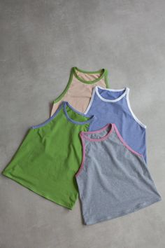 three tank tops sitting next to each other