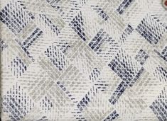 an upholstered blue and white fabric with diamond design on it's edges