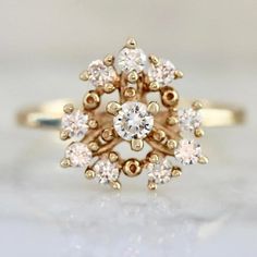 a gold ring with white stones on it's center and two rows of diamonds in the middle