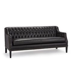 a black leather couch with wooden legs