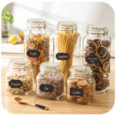 the jars are filled with different types of pasta and other food items, all labeled with labels