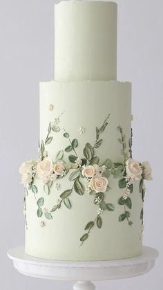 a three tiered white cake with flowers on it