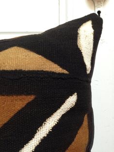 a black and brown pillow sitting on top of a white door