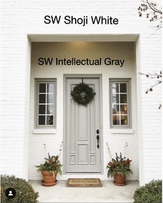 a white door with two potted plants in front of it and the words sw intelectual gray written below