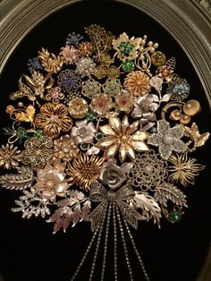 a bunch of brooches that are sitting in a vase on a table top