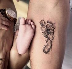 a person with a tattoo on their arm next to another person's leg and wrist