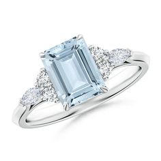 an aqua blue topazte and diamond ring with three diamonds on the band, set in