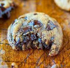 a chocolate chip cookie on a cutting board