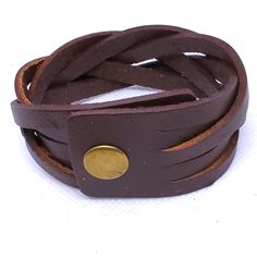 Add A Touch Of Punk, Bohemian, And Western Style To Your Outfit With This Brown Braided Faux Leather Snap Cuff Bracelet. Measuring 8.5 Inches In Length, This Cuff Bracelet Is Perfect For Any Occasion And Is Adjustable For Comfortable Wear. The Metal Snap Closure Ensures That The Bracelet Stays Securely In Place, While Providing Durability. This Bracelet Features A Unique Design That Is Both Stylish And Versatile. With No Stones And A Rectangular Shape, It Is A Perfect Addition To Any Jewelry Col Adjustable Leather Punk Cuff Bracelet, Brown Punk Leather Bracelet For Gift, Brown Leather Punk Style Jewelry, Punk Style Brown Leather Jewelry, Brown Cuff Leather Bracelet, Adjustable Brown Punk Bracelets, Handmade Punk Leather Bracelet, Handmade Leather Punk Bracelet, Brown Leather Cuff Bracelet