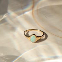 Meet your new favorite statement ring - the Opal Signet Ring. With just the right amount of sparkle and flash, this Australian opal ring makes a gorgeous statement by itself - or paired with your favorite stacked rings. It's made of 14k solid gold, so it'll last many lifetimes. After you're done with it, you can pass it on as an heirloom! DETAILS 14k solid gold ring 5mm x 7mm Australian opal Available in sizes 5-8 Weight: 1.5g Safe for sensitive skin & shower safe Matching jewelry: Oval Opal Nec