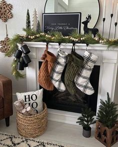 stockings hanging from the mantel in front of a fireplace with christmas decorations on it