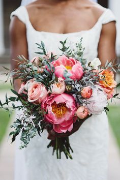 a bride holding a bouquet of flowers in her hands