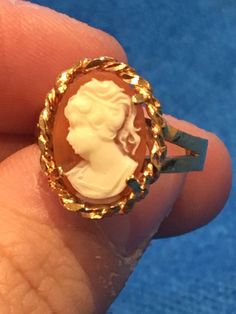 Beautiful vintage gold 10k cameo ring. Approximately created in the 1960s  this vintage beauty is sure to make a statement and become a conversation piece in any setting, great gift for any vintage lover or vintage treasure collector. Crafted in 10k gold it is stamped and hallmarked as so. This mid century ring  portrays the hand carved image of a young lady. The ring is approximately size 7.5 and can be sized by your local jeweller. The natural light shimmers off the buttery piece as if melting Sterling Bracelets, Cameo Ring, Vintage Lover, Vintage Beauty, 10k Gold, Conversation Piece, Rings Statement, Vintage Gold, Natural Light