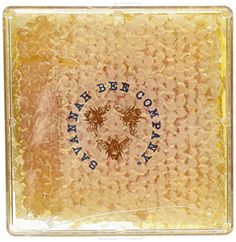 a bee company soap bar with bees on the front and bottom, sitting in a clear plastic case