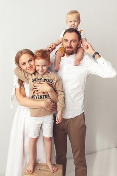 a man, woman and child are posing for a family photo with their arms around each other