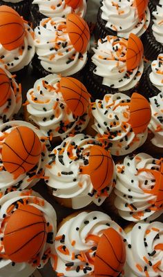 cupcakes with white frosting and orange sprinkles are arranged in a basket ball pattern