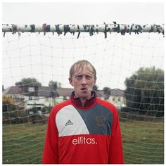 a man standing in front of a soccer net