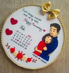 an embroidered ornament with a couple hugging each other and hearts on the side