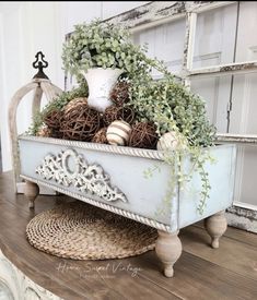 an old window sill with some plants and balls in it on top of a wooden table