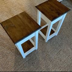 two wooden tables sitting on top of a carpeted floor