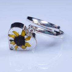 Beautiful sterling silver adjustable ring with a real sunflower in resin. Adjustable Yellow Open Ring Jewelry, Yellow Adjustable Open Ring Jewelry, Adjustable Yellow Flower Ring For Gift, Adjustable Sunflower Design Flower Ring, Adjustable Yellow Sterling Silver Rings, Adjustable Sterling Silver Yellow Ring, Adjustable Silver Ring With Sunflower Design, Adjustable Sunflower Design Flower Ring Gift, Real Sunflower