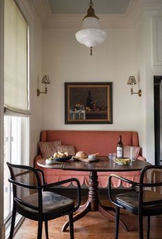 a living room with a couch, table and chairs