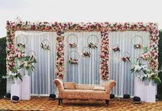 a couch sitting on top of a stage covered in flowers