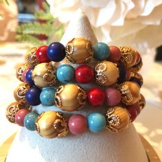 This Stackable Bracelet Set Adds A Touch Of Bohemian Charm To Any Outfit. The Bracelets Feature A Mix Of Beads In Tan, Lavender, Orange, Blues, Reds, And Gold Accents, Making Them Versatile For Any Occasion. The Stackable Design Allows For Customization And The Charm Type Is Beaded To Add A Unique Touch. Perfect For Those Who Love Stylish Accessories That Can Be Mixed And Matched, These Bracelets Are A Great Addition To Any Jewelry Collection. Skus:A91 Bohemian Blue Beaded Bracelets With Wooden Beads, Blue Bohemian Beaded Bracelets With Wooden Beads, Turquoise Bracelet With Wooden Beads For Gift, Turquoise Bracelet With Wooden Beads, Bohemian Blue Bracelets With Wooden Beads, Blue Wooden Beaded Bracelets As Gift, Bohemian Crystal Bracelet With Large Beads For Gift, Bohemian Beaded Multicolor Rosary Bracelet, Bohemian Multicolor Beaded Rosary Bracelet