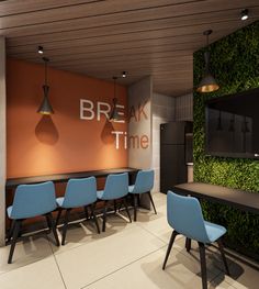 an office break room with blue chairs and a green wall behind the desks that reads break time