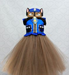 a tutu skirt with a cat mask on top and a blue jacket over it