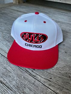 This genuine 1990s vintage adjustable Chicago Bulls snapback hat is in excellent condition! Looks like it has never been worn. It still has the cardboard headliner. Check the pics. I'd say it is medium profile. Officially Licensed by the NBA. 65% polyester, 35% cotton. Measurements: Brim: 2.75" (from end of bill to headpiece) Front: 3.00" (from base to top - not to crown) Retro Flat Brim Snapback Hat For Baseball Season, Throwback White Snapback Baseball Cap, White Throwback Snapback Hat For Sports Events, Retro Snapback Hat With Curved Bill And Embroidered Logo, White Retro Trucker Hat With Curved Brim, Retro White Trucker Hat With Curved Brim, Retro Flat Bill Baseball Cap For Streetwear, Retro Embroidered Logo Snapback Hat For Streetwear, Retro Snapback Hat With Embroidered Logo