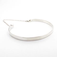 This cuff bracelet made of sterling silver and has a shiny finish. It has a chain attached to it for extra security and additional style. Its edgy style fits well with casual fashion. Perfect as a gift to stylish girl or woman. If you like simplicity, this piece is for you! Measurements: bracelet width 4 mm= 0.15 in.  Please choose your size. The measurement is the length of the bracelet, the length of silver stripe. The gap is 1.2 inch. If you need size that you dont see here, please convo me! Silver Cuff Bracelet With Adjustable Chain, Polished Sterling Silver Minimalist Bracelet, Minimalist Sterling Silver Bracelet With Polished Finish, Sterling Silver Minimalist Bracelet With Polished Finish, Modern Sterling Silver Chain Bracelet Bangle, Modern Sterling Silver Bangle Chain Bracelet, Modern Sterling Silver Chain Bracelet, Modern Bangle With Sterling Silver Clasp, Modern Silver Everyday Choker